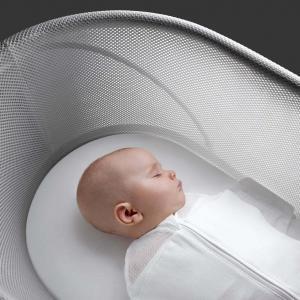 Baby peacefully and safely sleeping in a SNOO Smart Sleeper Bassinet