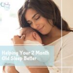 Mom cuddling her 2 month old baby while smiling, baby’s face not visible, showing a loving bedtime moment