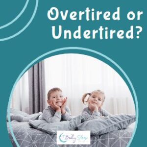 twin toddlers awake in bed looking alert and happy, possible overtired or undertired at bedtime