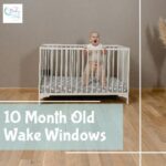 10 month old baby standing in crib awake during wake window before bedtime